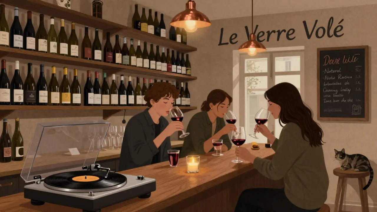 A hidden wine bar with shelves of French bottles and patrons tasting natural wines by candlelight.